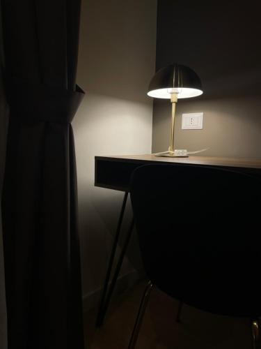 a lamp sitting on a desk next to a chair at Summertime in Bisceglie