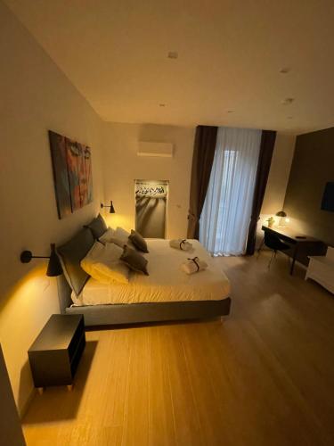 a bedroom with a large bed and a desk at Summertime in Bisceglie