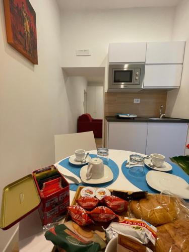 a kitchen with a table with food on it at Summertime in Bisceglie
