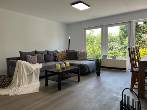a living room with a couch and a table at Strandhaus JP in Maasholm