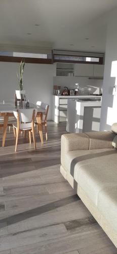 a living room with a couch and a dining table at Aizarker in La Plata