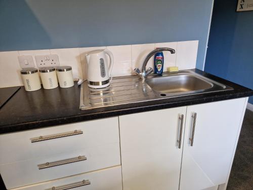 a kitchen with a sink and a counter top at Unique Studio II - Private Studio in Kent