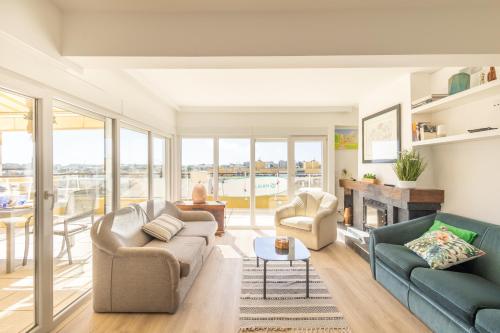 a living room with two couches and a fireplace at OceanFront & Big Terrace Private Condo in Oeiras