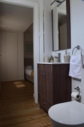a bathroom with a sink and a mirror at Casa dos Picoutos AL in Monção