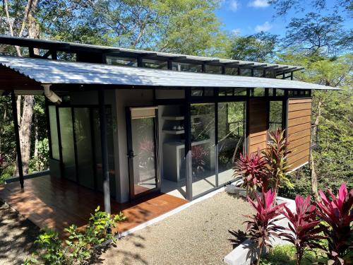a tiny house with a deck in the woods at Pacific Kalokairi - Adults Only in Tamarindo