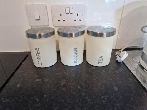 a group of three white buckets sitting on a counter at Chique Maidstone Studio II in Kent
