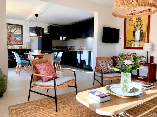 a living room with a table and chairs at Luxury Apartment St-Tropez/ 10mn walk to center. in Saint-Tropez