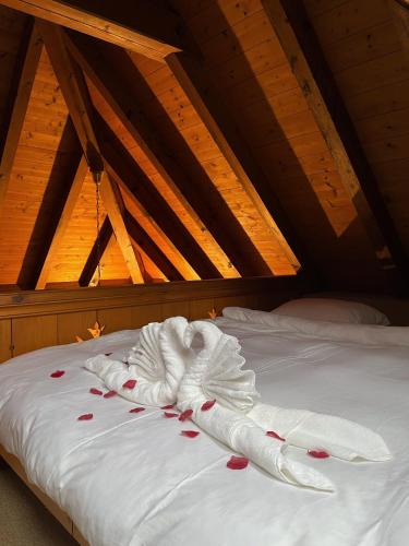 a white towel on a bed in a attic at Boutique B21 in Unterseen