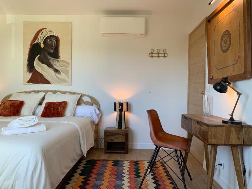 a bedroom with a bed and a desk and a chair at Luxury Apartment St-Tropez/ 10mn walk to center. in Saint-Tropez