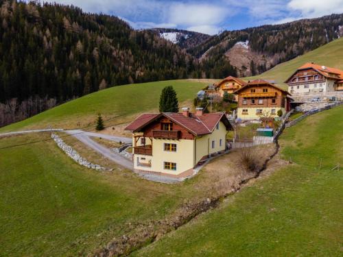 an aerial view of a house on a green hill at Wirnsberg in Aschbach