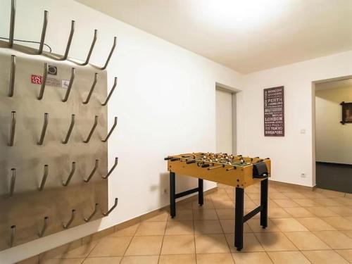 a ping pong table in a room with a wall of bullets at Wirnsberg in Aschbach