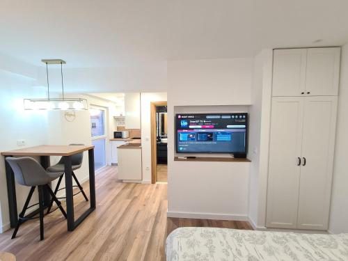 a living room with a table and a tv on a wall at Apartment Mara&Padrona in Zadar