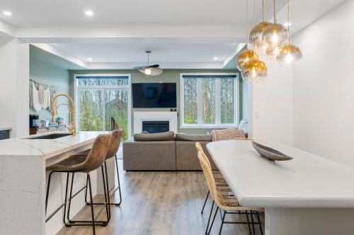 a kitchen and living room with a couch at Jewel of Blue Mountain - Walk to Ski and Village - EV plug in Blue Mountains