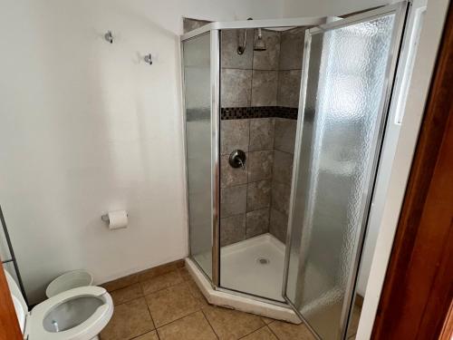 a bathroom with a shower and a toilet at Casa Mediterraneo in Ensenada