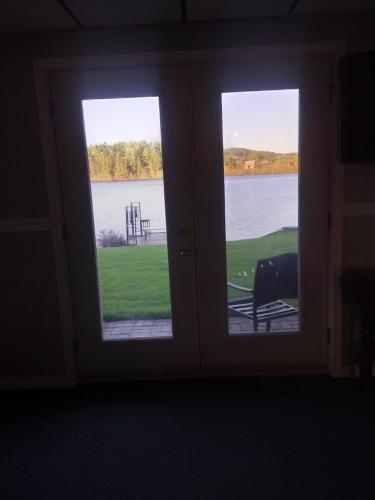 two windows in a room with a view of the water at Peaceful restful & fun on the water in Golden Lake