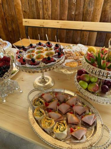 a table with several trays of food on it at ANGINE Resort Hotel in Vanadzor