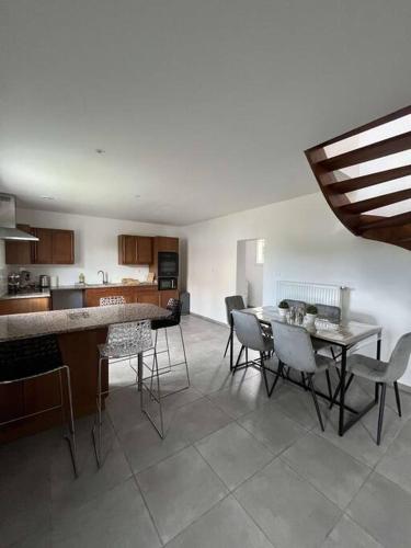 a kitchen and dining room with a table and chairs at La maison Dardenne in Villeneuve-sur-Lot