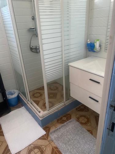 a shower with a glass door in a bathroom at La maison de la plage in Sainte-Luce