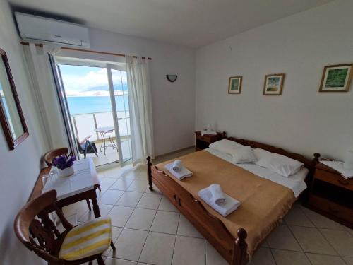 a bedroom with a bed with a view of the ocean at Villa Gabriel in Pag