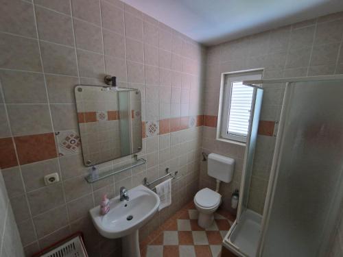 a bathroom with a sink and a toilet and a shower at Villa Gabriel in Pag