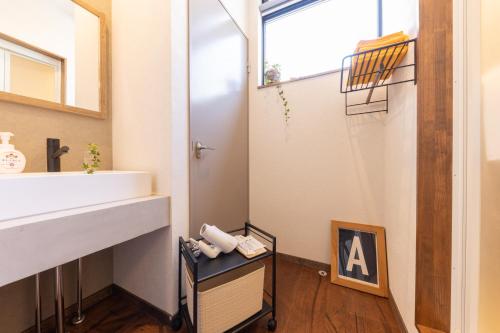 a bathroom with a sink and a mirror at KAjette - Takayama Apartment Hotel in Takayama