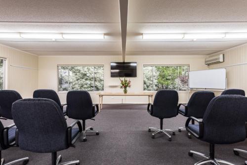 a conference room with chairs and a table and a tv at Panorama Retreat & Resort in Kalorama