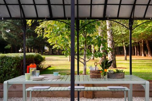 a picnic table under an umbrella in a park at Maison 24 in Trentham