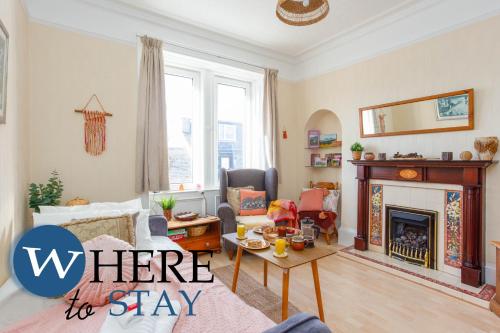a living room with a fireplace with the words where to stay at Bright 2bed apartment in Galashiels City Centre in Galashiels