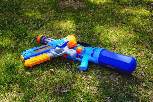 a toy gun is laying on the grass at サウナバーベキュージャグジー完全貸し切りという贅沢大人の秘密基地#01 in Miyota
