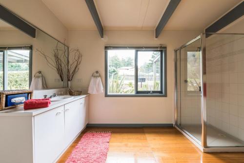 a bathroom with a shower and a sink at Panorama Retreat & Resort in Kalorama
