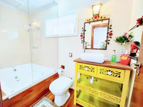 a bathroom with a sink and a toilet and a shower at Mouton Blanc Campos do Jordão in Campos do Jordão