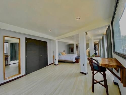 a room with a desk and a bedroom with a bed at Monaco in San Pedro La Laguna