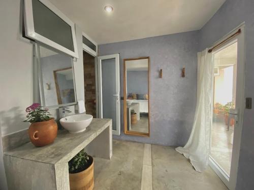 a bathroom with a sink and a mirror at Monaco in San Pedro La Laguna