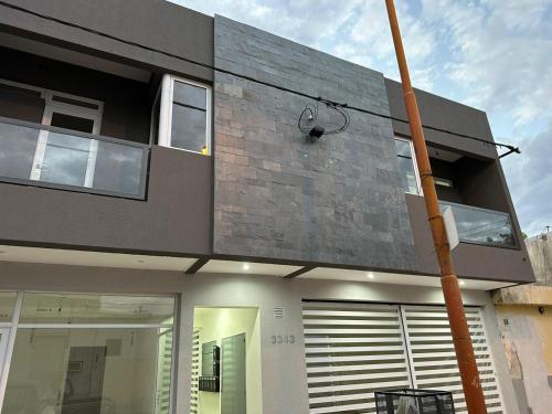 a modern house with a brick wall at DON SIMON Apart 8 -departamento nuevo in Esperanza