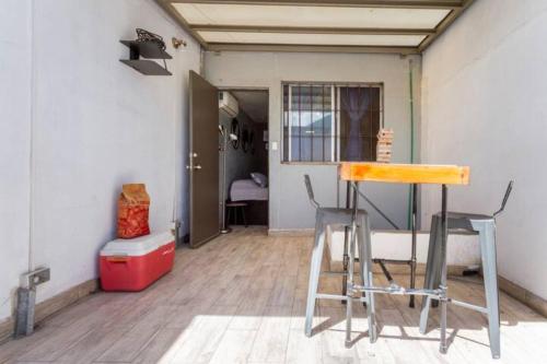 a room with a table and two stools in it at Agua Azul by Airhome in Monterrey