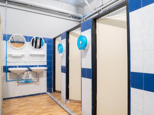 a bathroom with blue and white walls and mirrors at Leisure Hostel in Krabi town