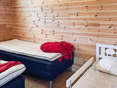 a room with a bed with a wooden wall at Holiday home Sunnemo in Sunnemo