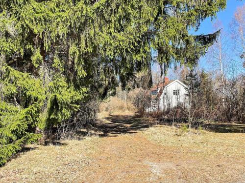 a tree with a house in the background at 4 person holiday home in HÖJE-By Traum in Höje