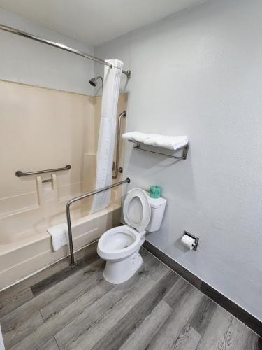 a bathroom with a toilet and a bath tub at Super 8 by Wyndham Shreveport in Shreveport