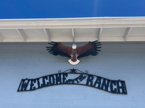 a sign with an eagle on the side of a building at El Rancho Motel in Williams