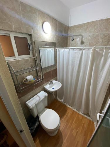 a bathroom with a toilet and a sink at Hotel Campestre Imperial in Huasca de Ocampo