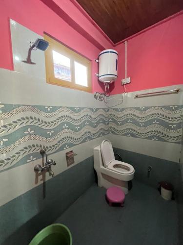 a bathroom with a toilet and a sink at Sunrise Guest House - Tosh in Tosh