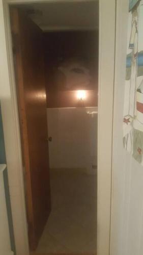 a reflection of a person in a bathroom mirror at Cozy, cute beach condo in Westerly RI . Best value in Westerly!! in Westerly