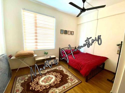 a bedroom with a red bed and a ceiling fan at Marit's Homestay Sandakan in Sandakan