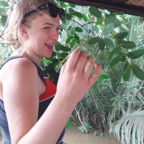 a woman with sunglasses on her head holding a plant at BenTrestay in Giồng Tú Ðiền