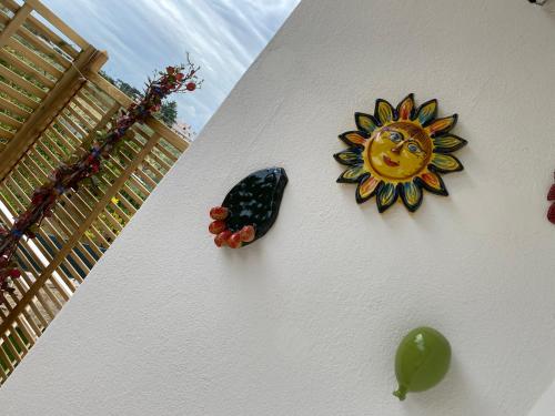 a clock on a wall with a sun on it at Dimore Capirro Charming Family House in Trani