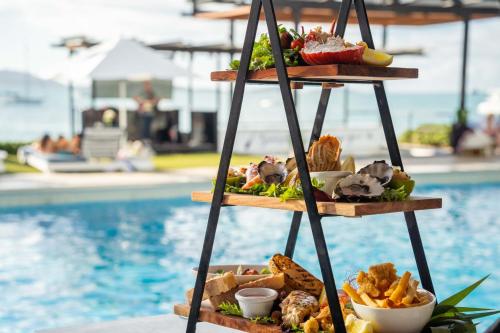 a tray of food sitting next to a pool at Coral Sea Resort in Airlie Beach