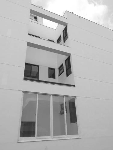 a black and white photo of a building with windows at Kenting Onehome in Checheng