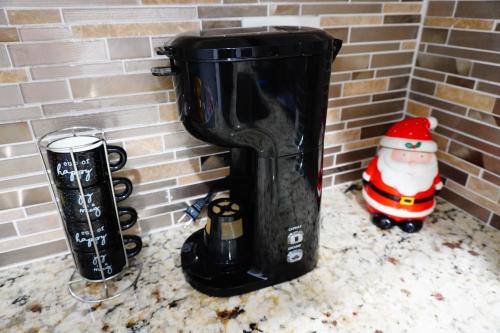 a black ice bucket against a brick wall with a santa clause at Summer Breezes in Holiday