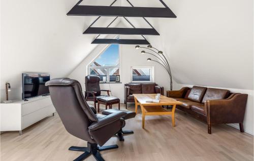 a living room with a couch and a chair and a table at Lovely Apartment In Hemmet in Hemmet